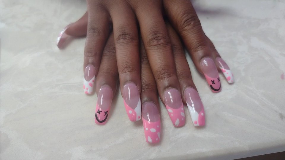 Nail technician painting a fresh manicure